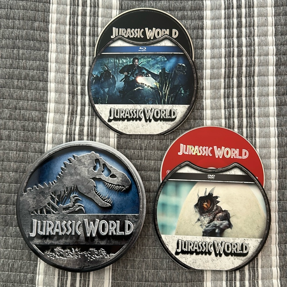 Jurassic World DVD and collectible metal tin